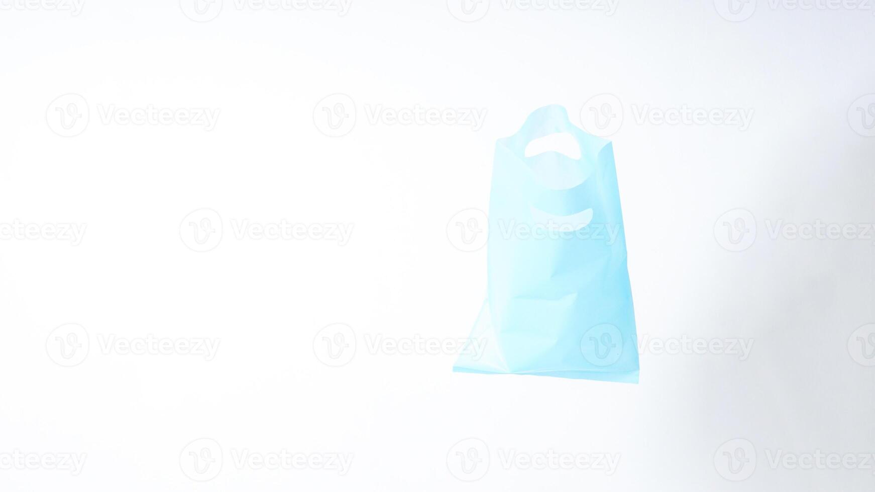 Open Light Blue Plastic Bag on White Background photo