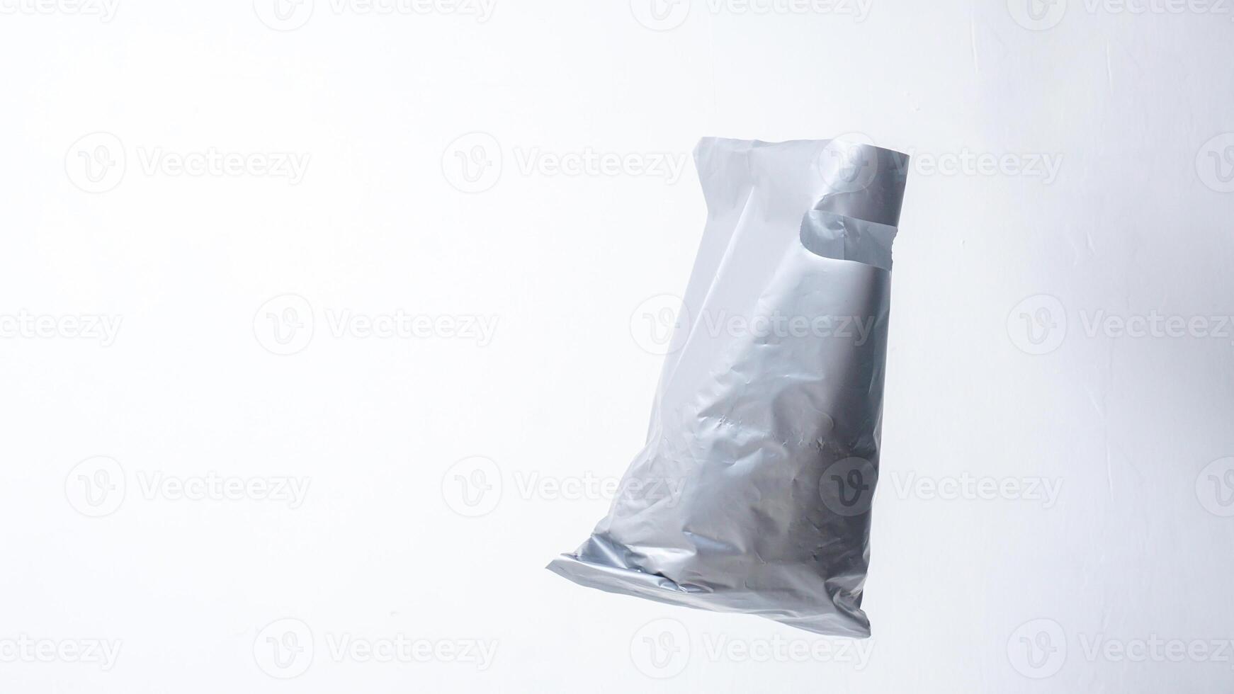 Open Used Gray Plastic Bag with Handle on White Background photo