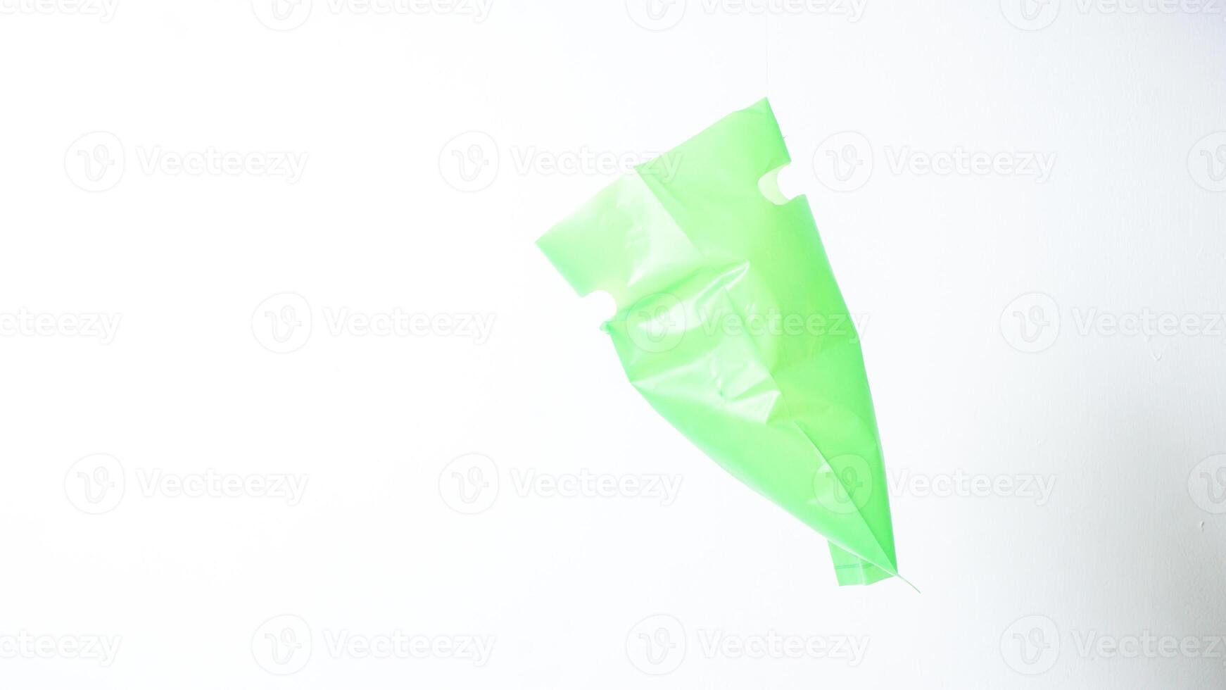 Side View of Open Green Plastic Bag with Handle on White Background photo