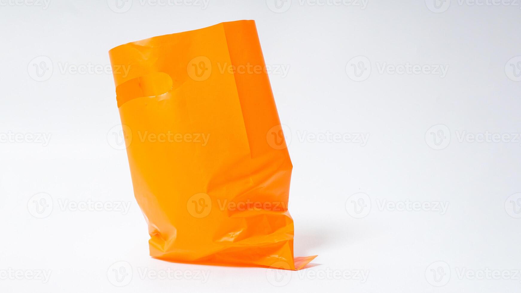 Empty Open Orange Plastic Bag on White Background photo