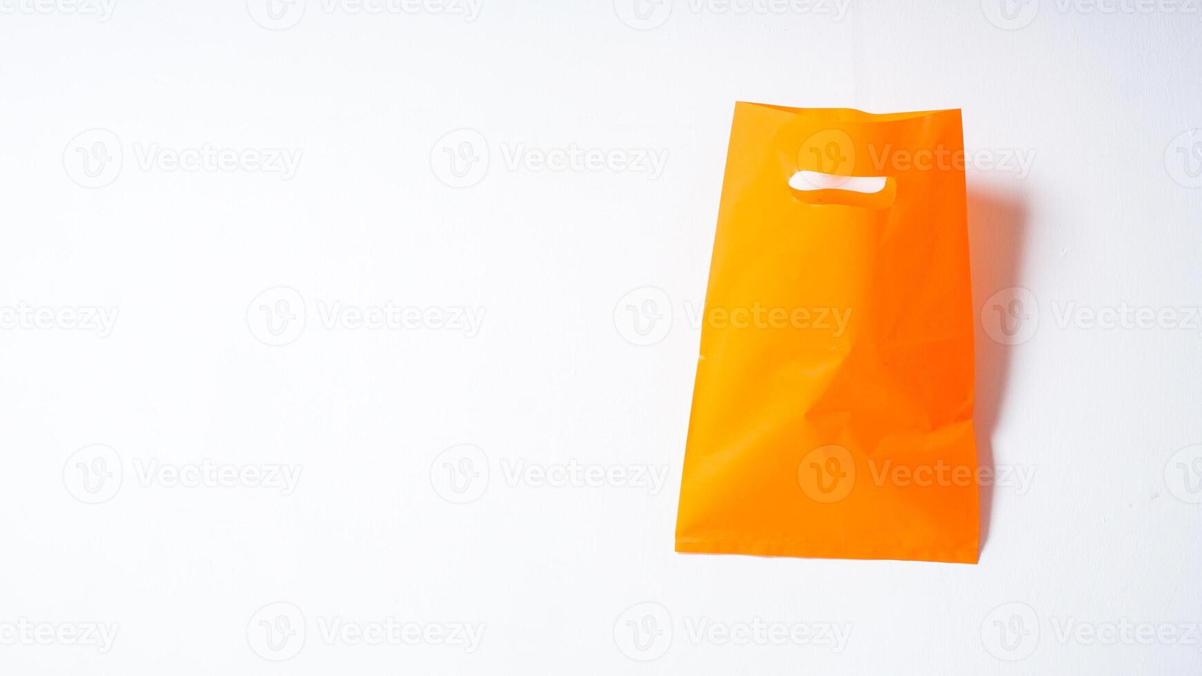 Open Blank Orange Plastic Bag Mock Up on White Background photo