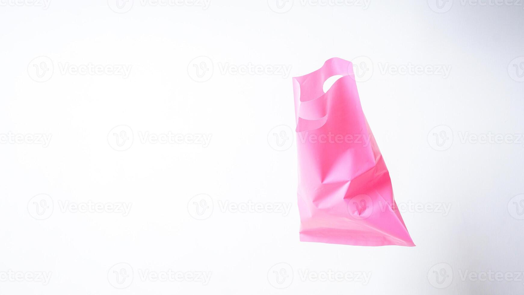 Open Pink Plastic Bag with Handle on White Background photo