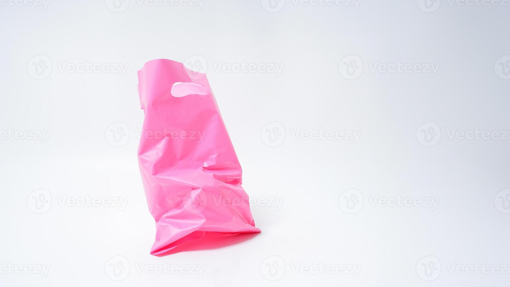 Open Used Pink Plastic Bag on White Background photo