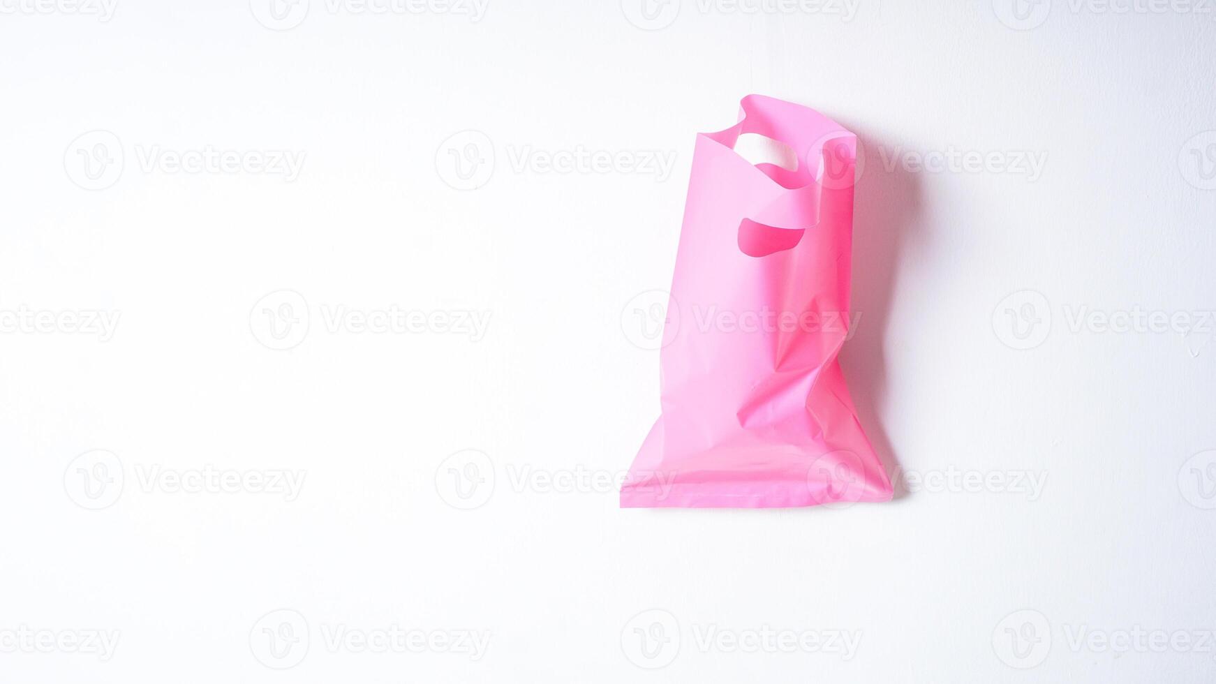 Open Pink Plastic Bag on White Background photo
