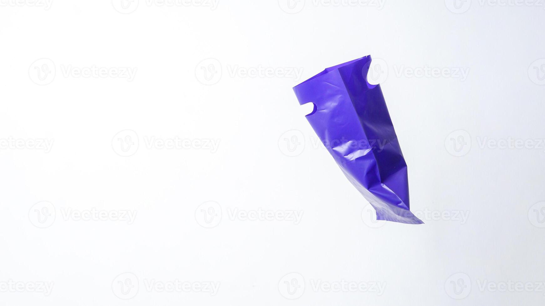 Side View of Open Purple Plastic Bag with Handle on White Background photo