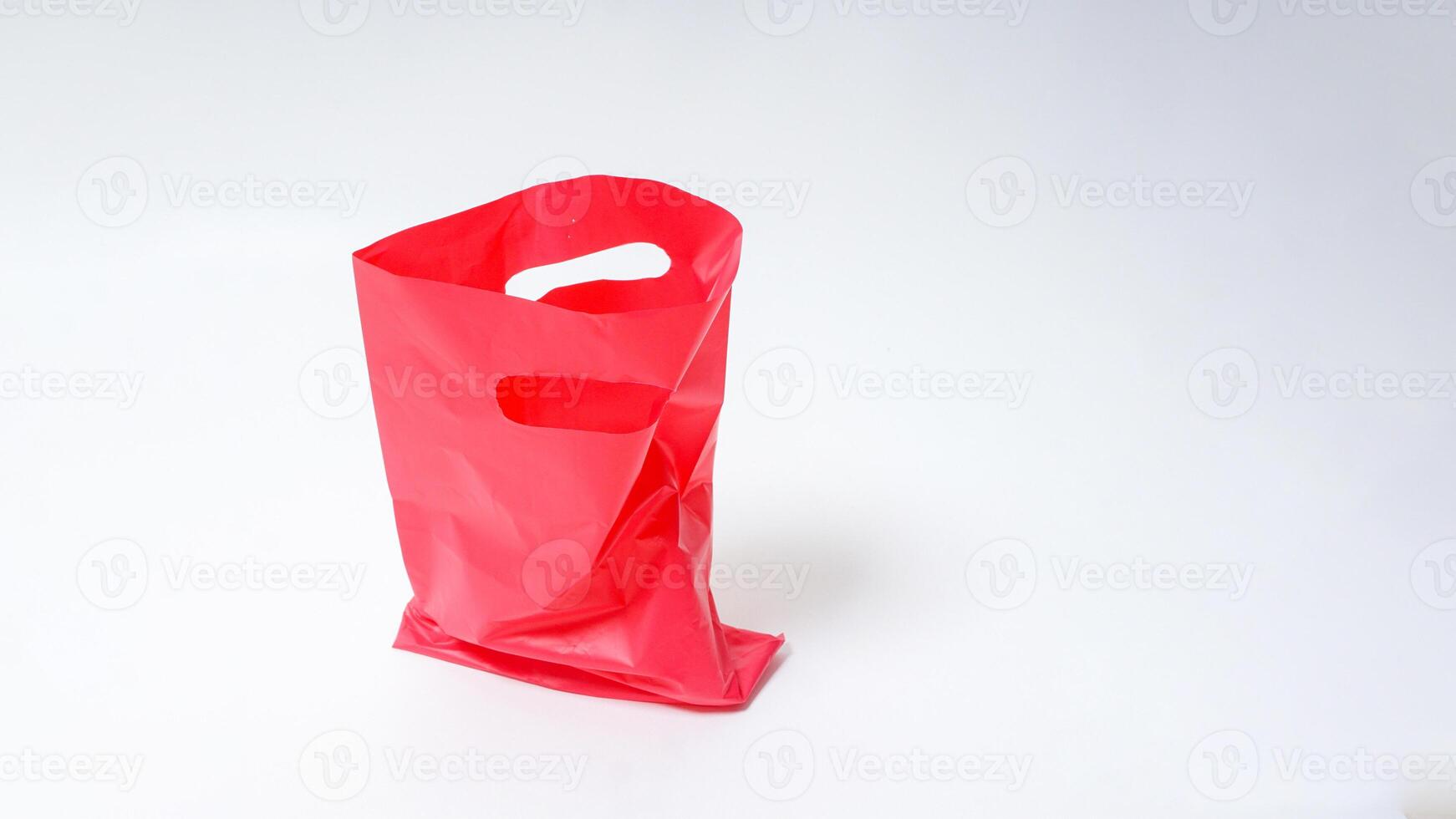 Empty Open Red Pink Plastic Bag on White Background photo