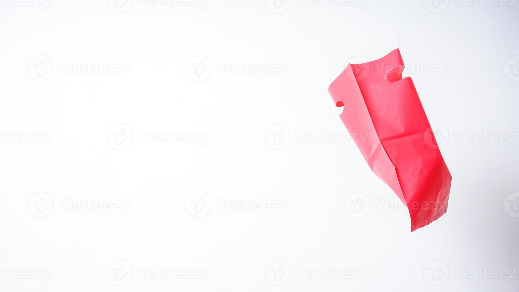 Flying Red Pink Plastic Bag Mock Up with Copy Space on White Background photo