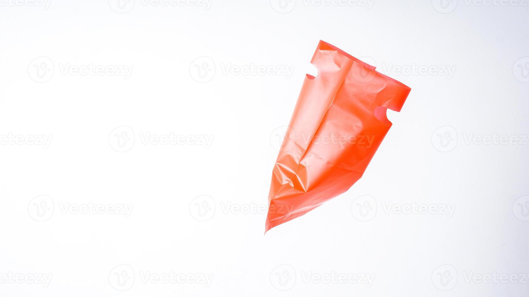Side View of Open Red Plastic Bag on White Background photo