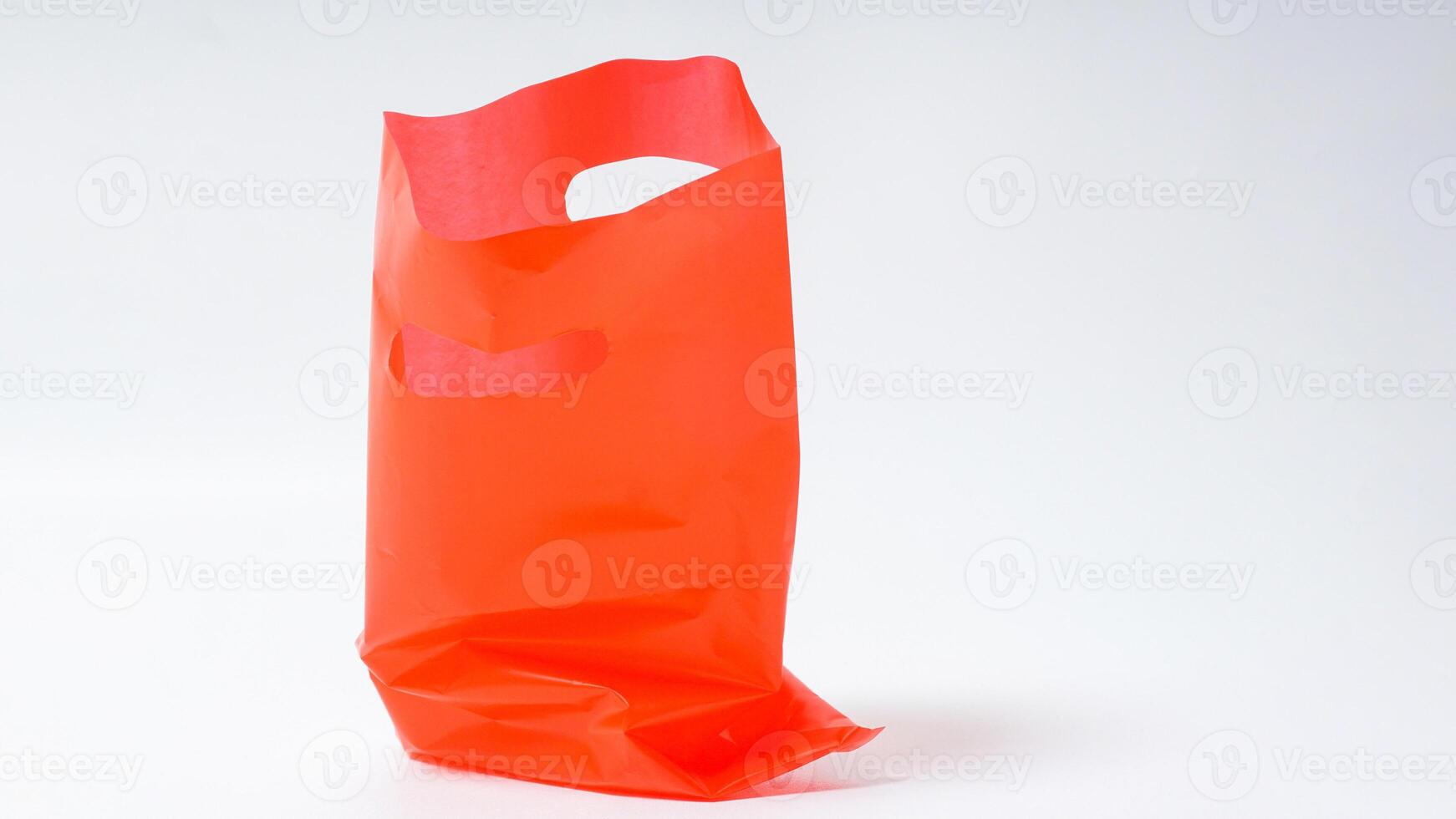 Empty Open Red Plastic Bag on White Background photo