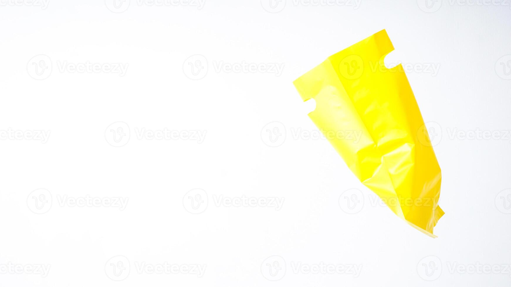 Side View of Open Yellow Plastic Bag with Handle on White Background photo