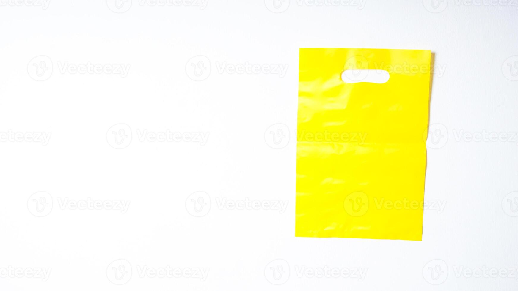Blank Yellow Plastic Bag Mock Up on White Background photo