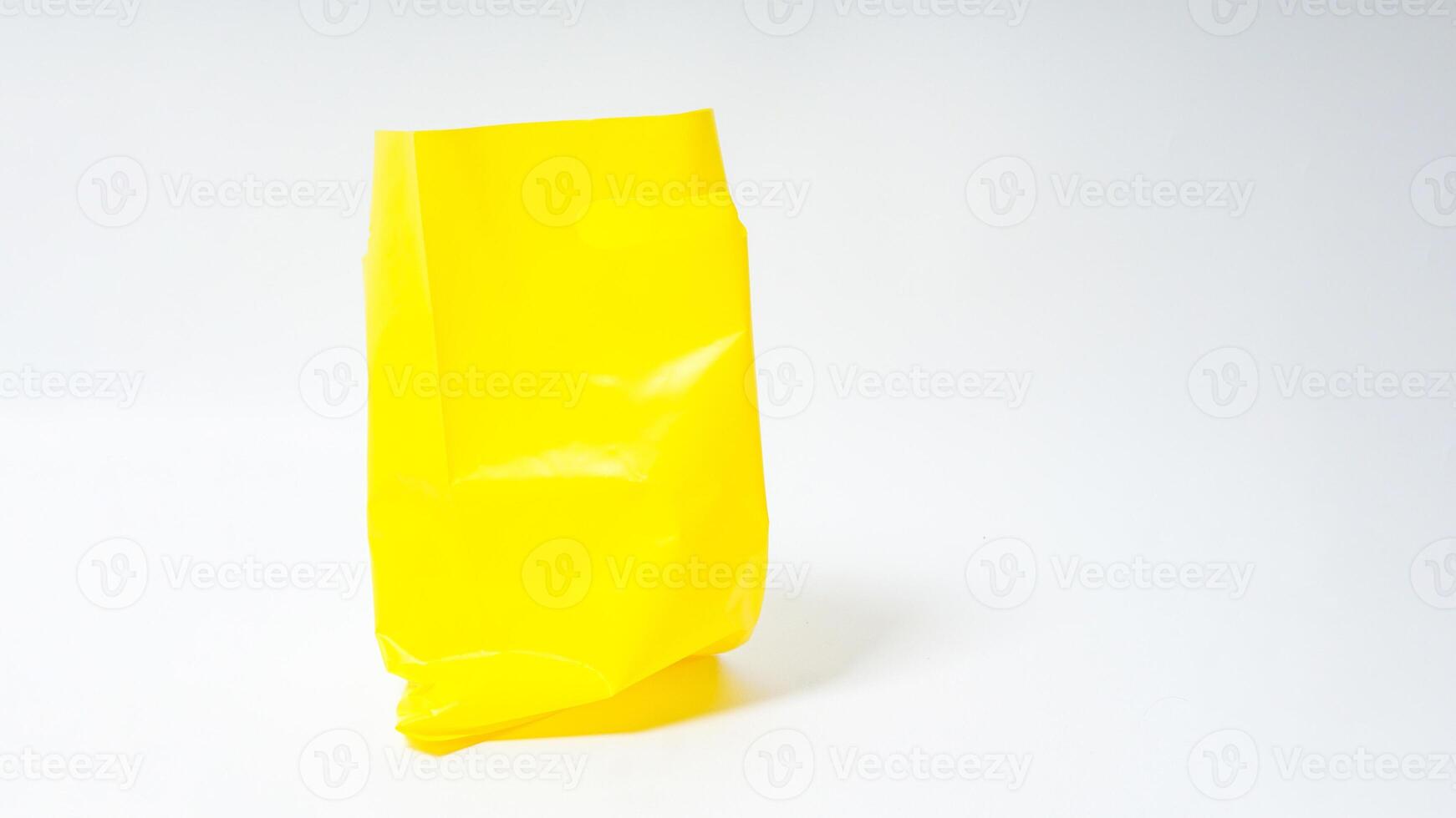 Empty Open Yellow Plastic Bag on White Background photo