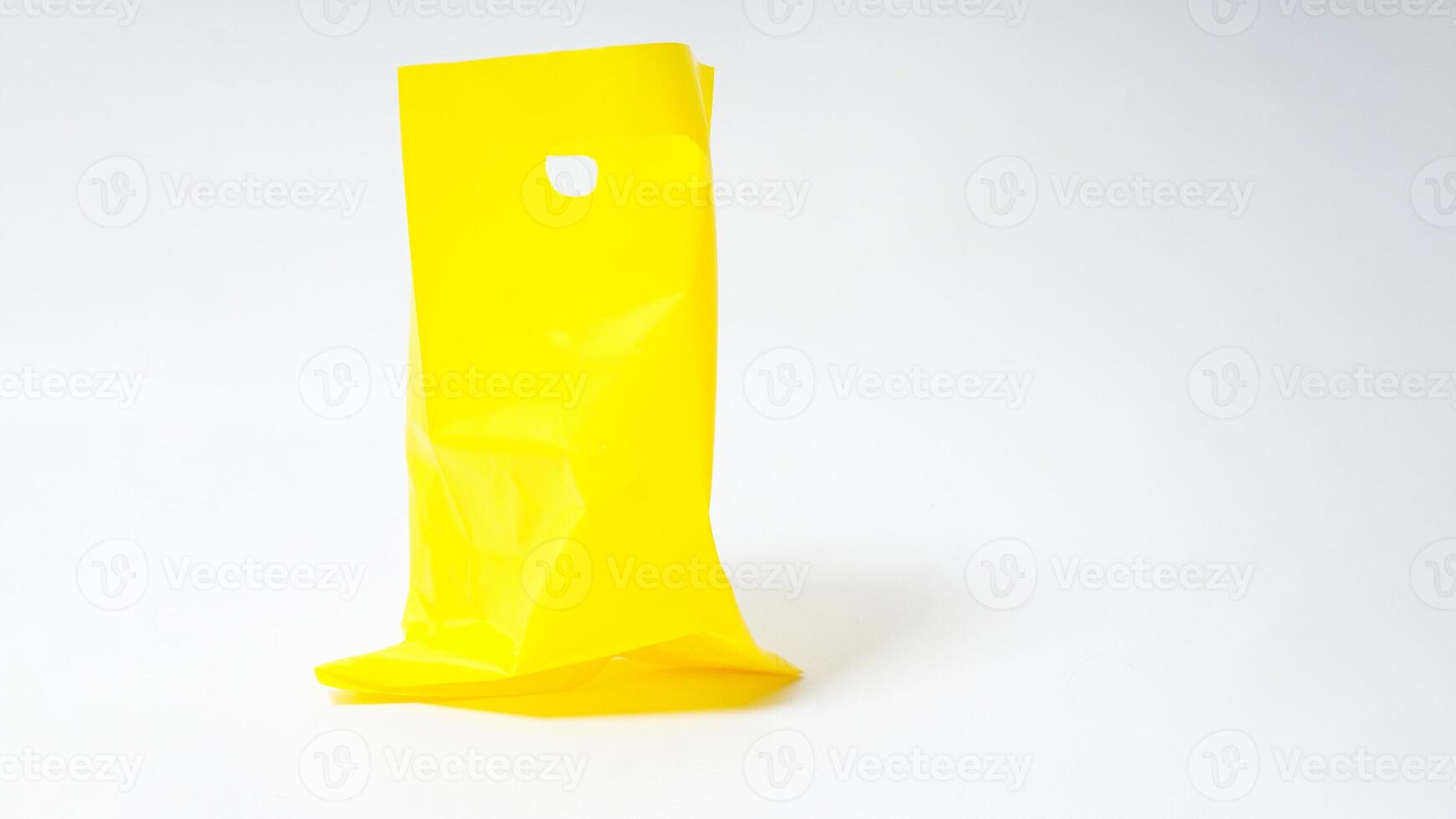 Empty Open Yellow Plastic Bag Mock Up with Handle on White Background photo
