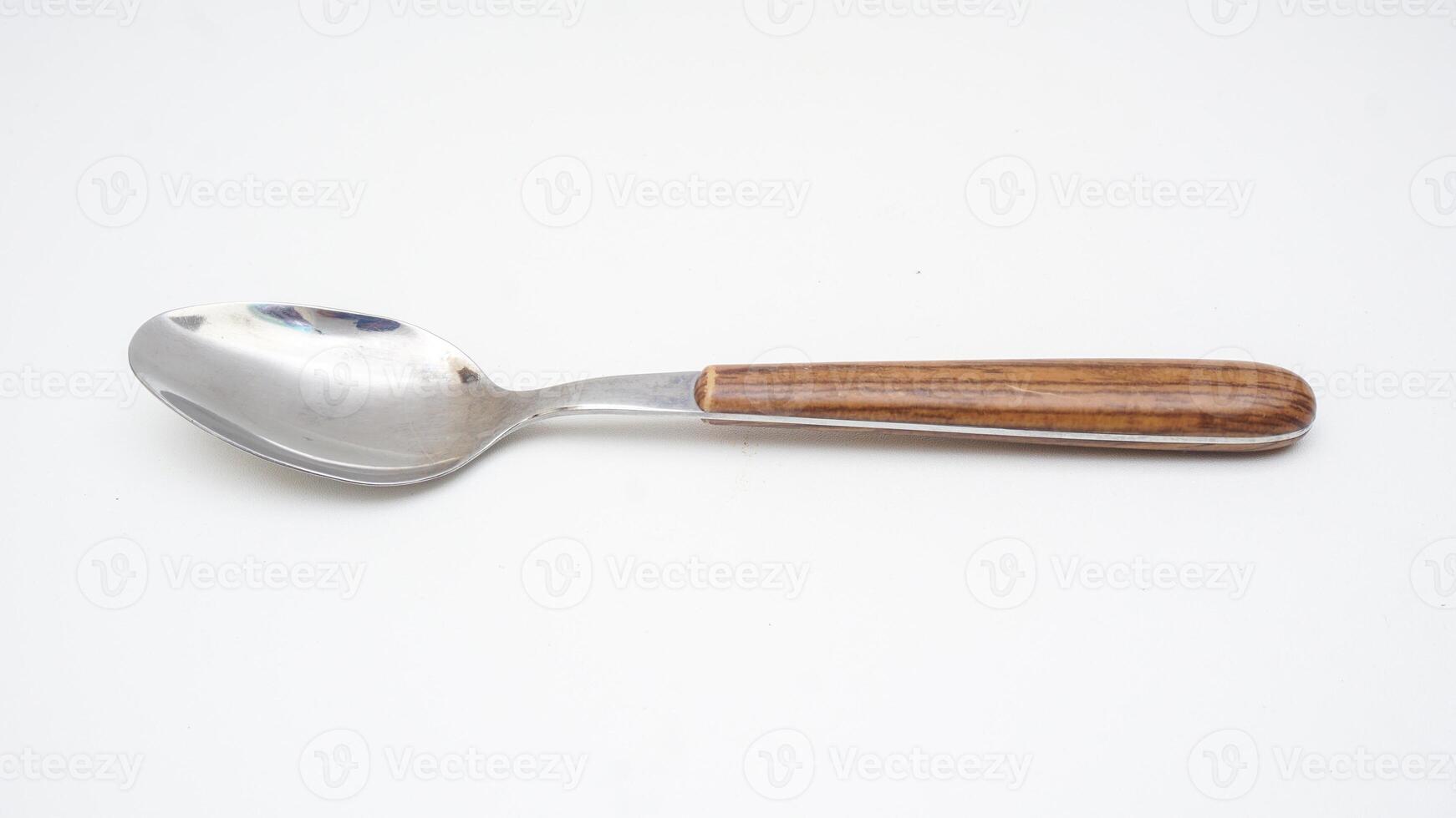 Stylish stainless steel spoon with wooden handle isolated on white background photo