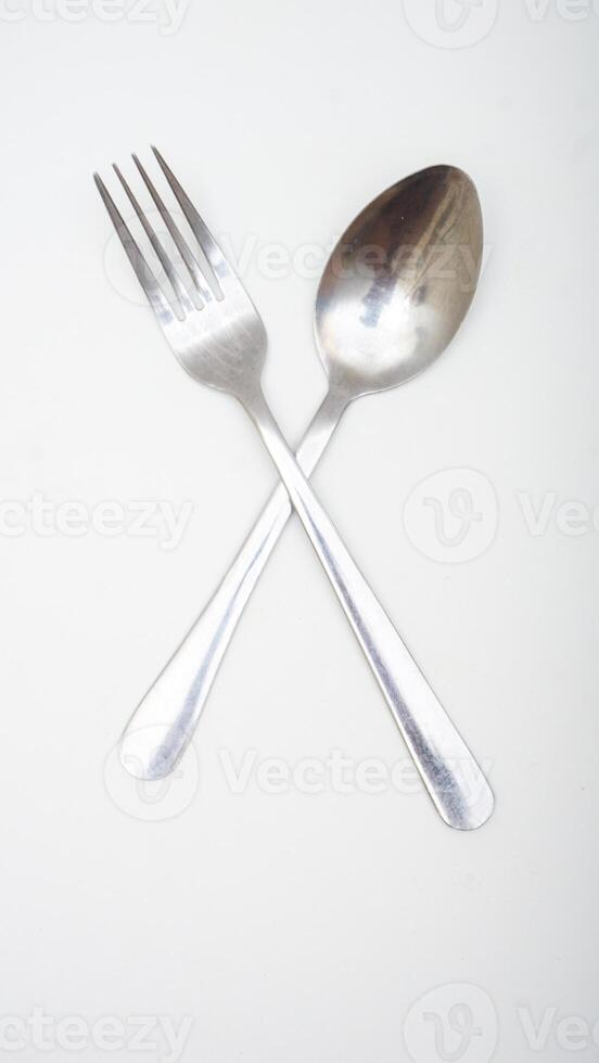 A pair of stainless steel spoon and fork isolated on white background photo