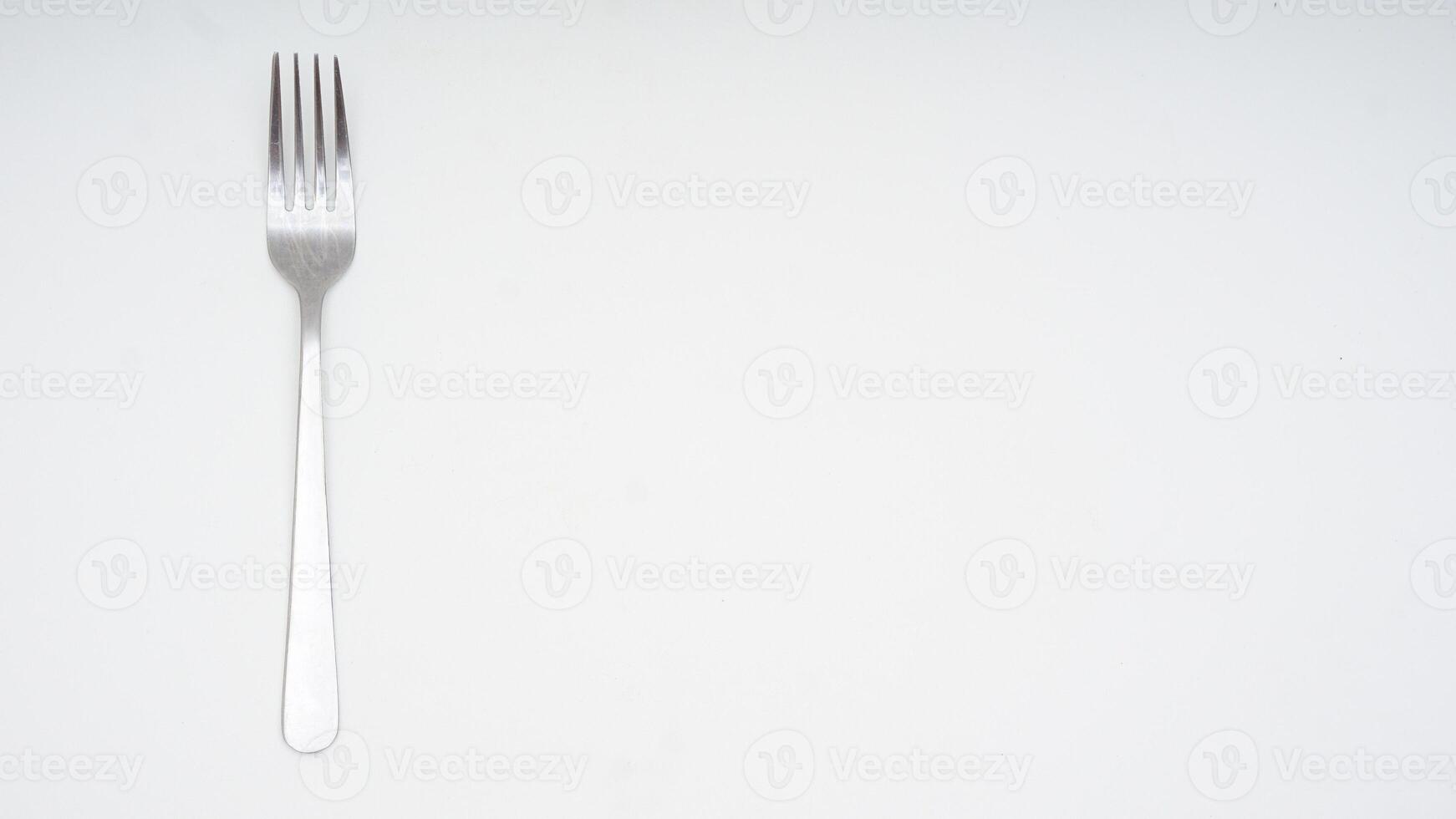 Stainless steel fork with copy space isolated on white background photo