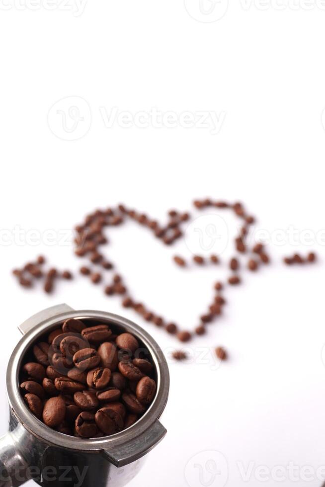 Portafilter with coffee beans and heart shape on white background photo
