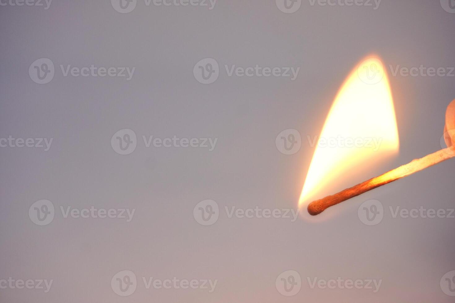 Burning matchstick with bright flame close-up photo