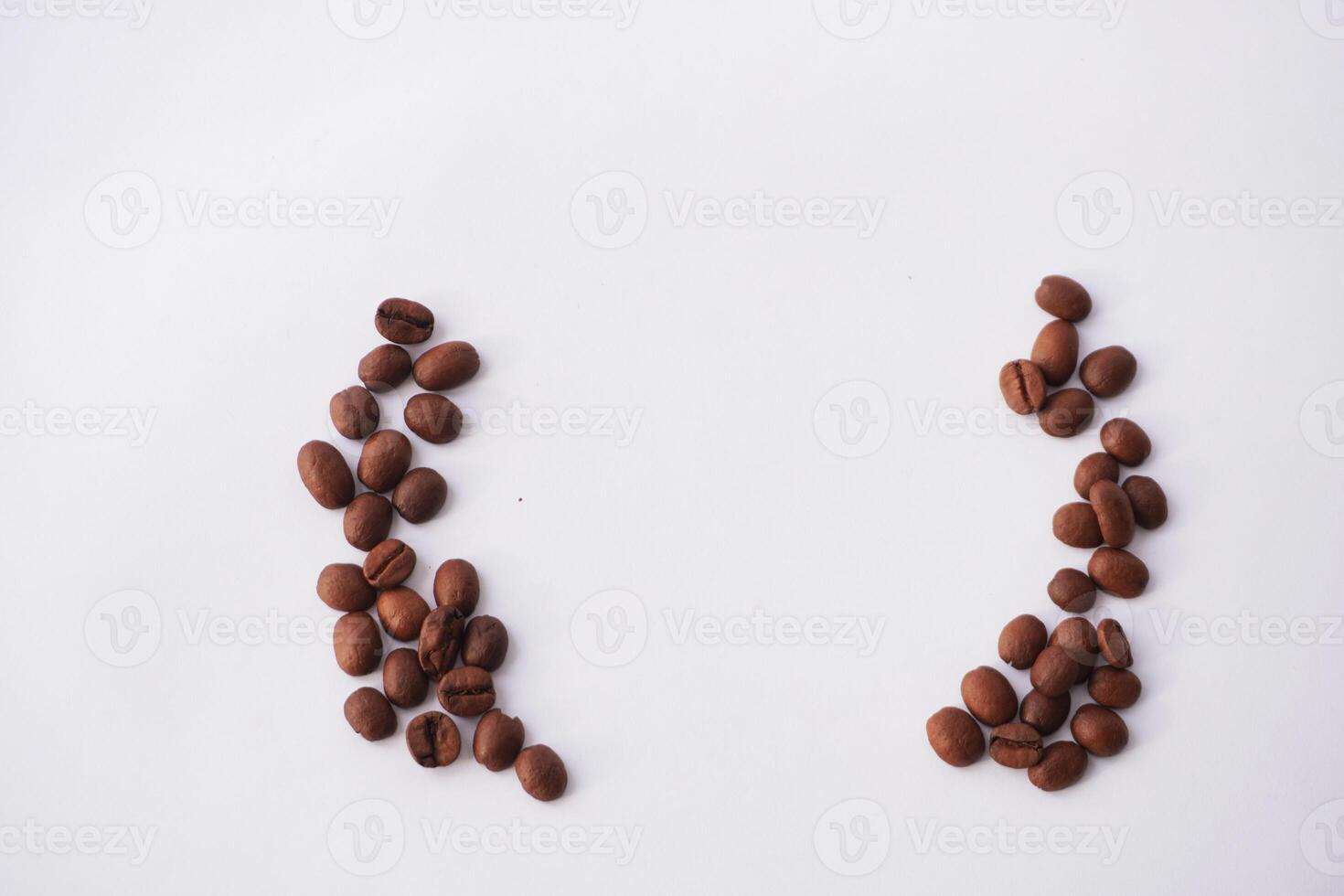 Coffee beans arranged symmetrically on white background photo