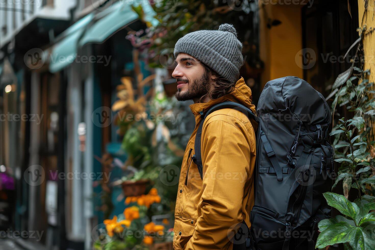 A man with a backpack standing in the street photo
