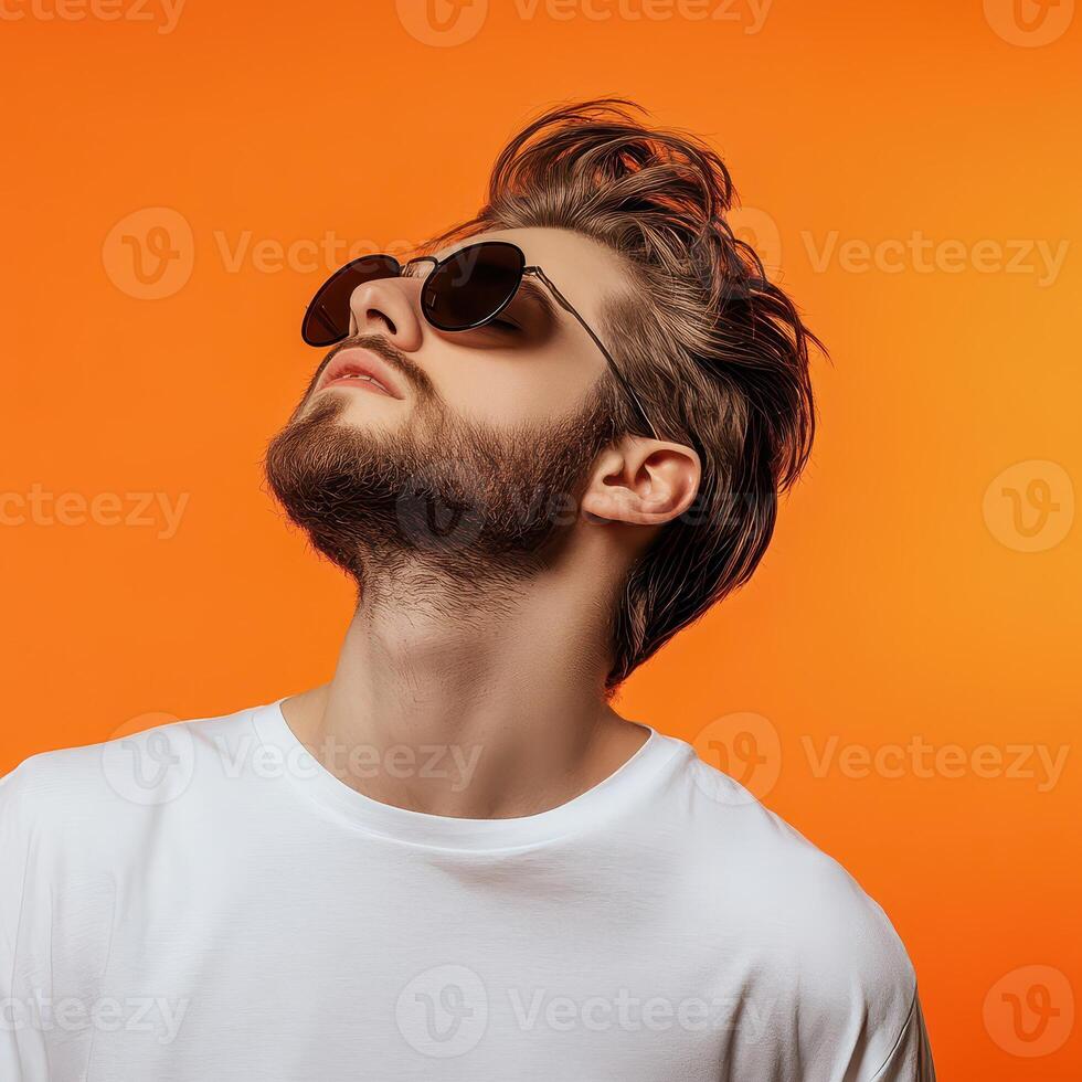 A man with sunglasses on an orange background photo