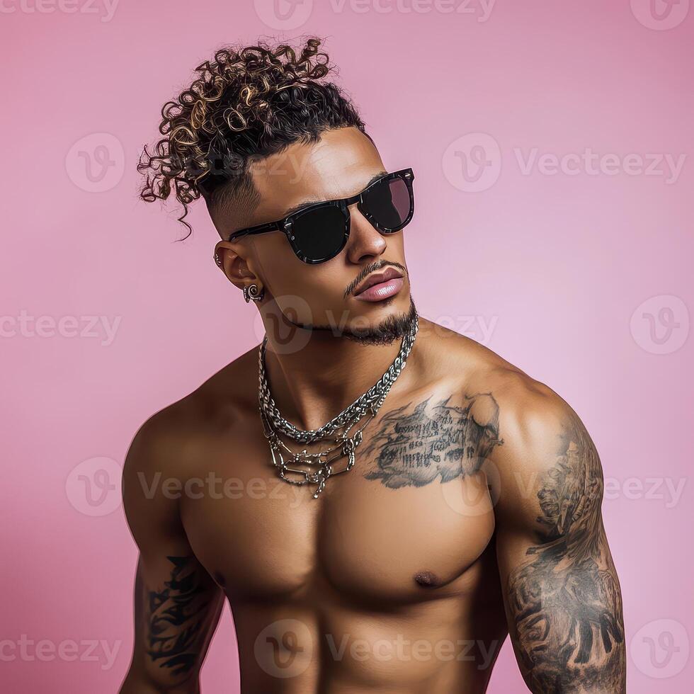 A shirtless man with tattoos and sunglasses photo