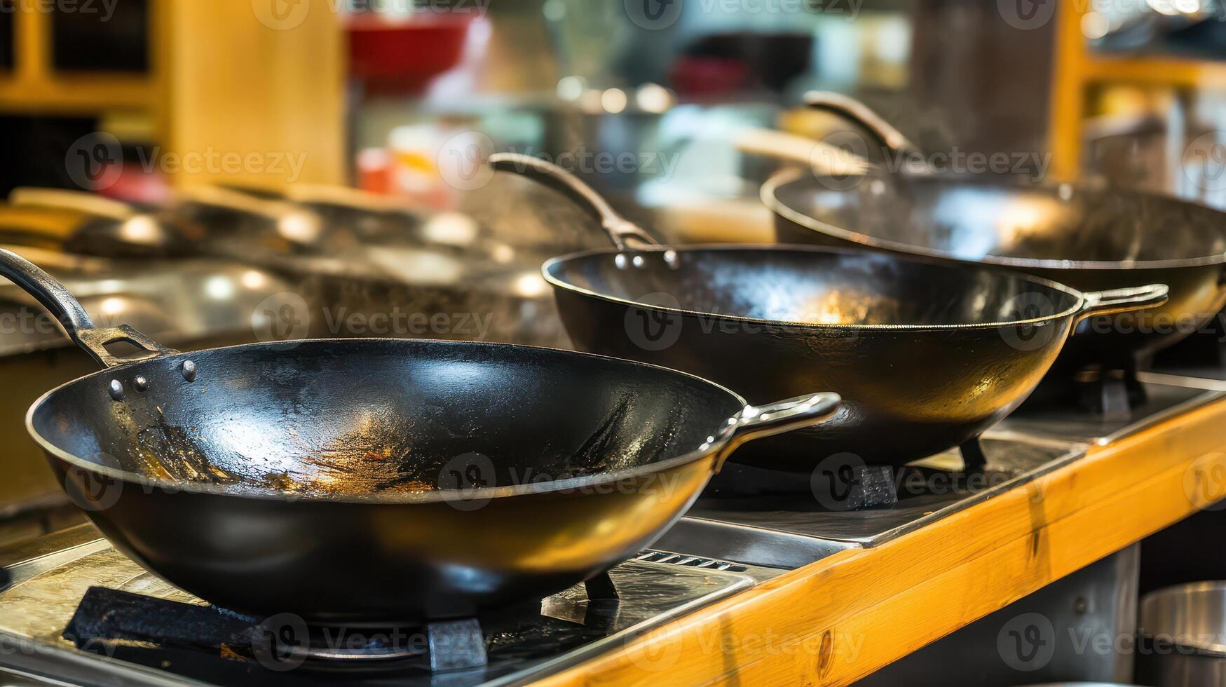 A line of woks on a stove photo