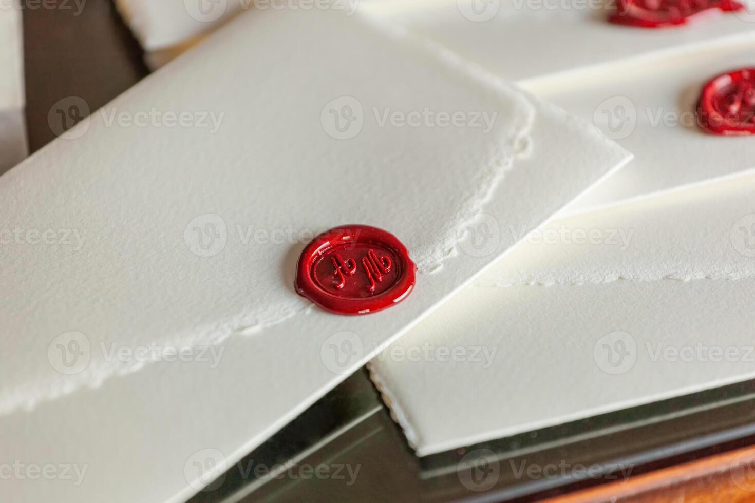 Sealing wax sealing elegant invitations on parchment paper photo