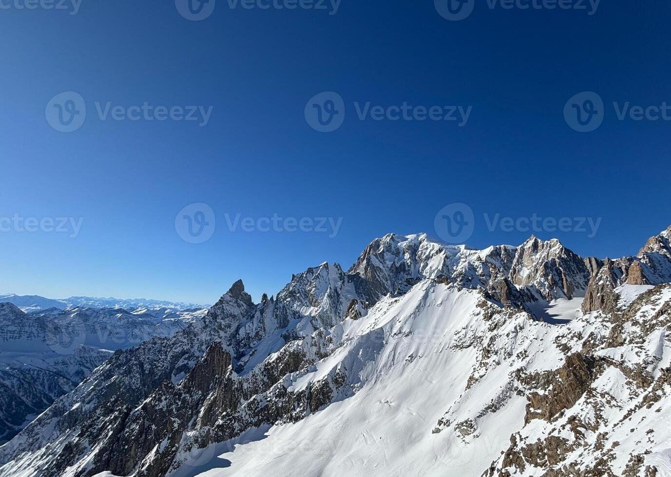 Mont Blanc massif towering over snowy landscape in Courmayeur, Italy photo