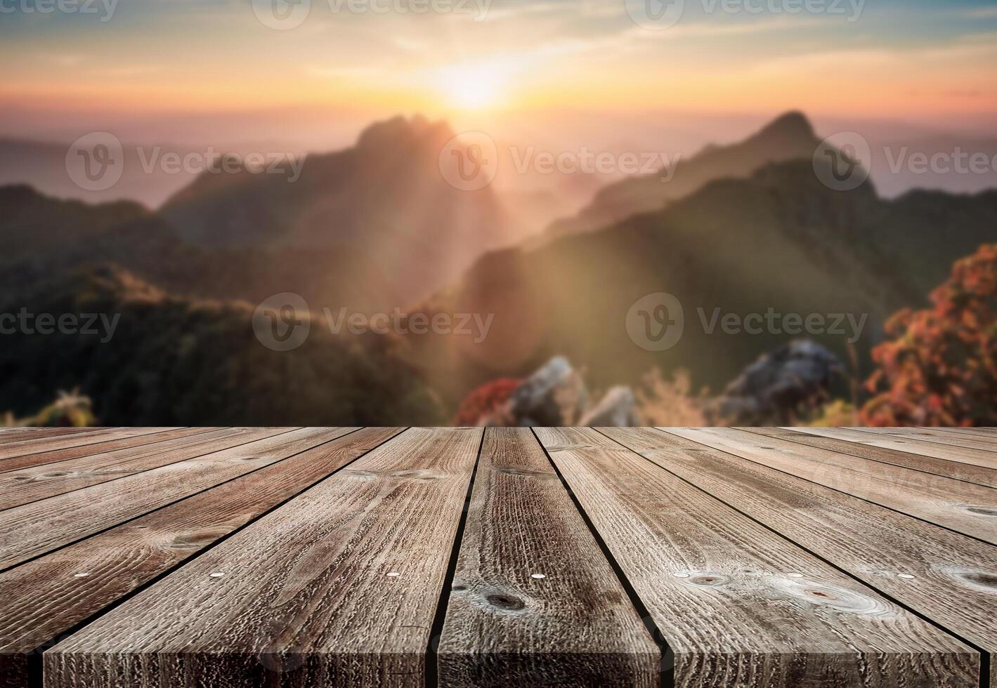 Wooden table top on blurred sunset on mountain in wildlife sanctuary at Doi Luang Chiang Dao national park photo