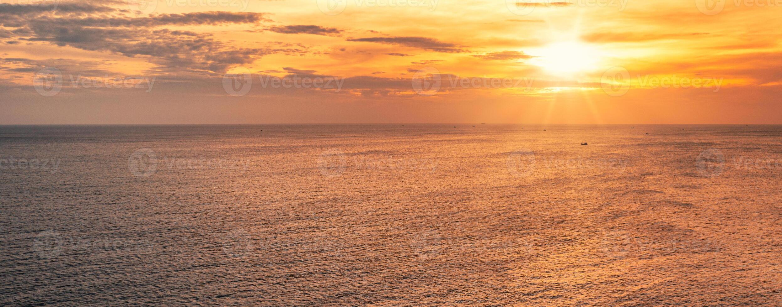 Sunset over horizon on tropical sea with boat photo