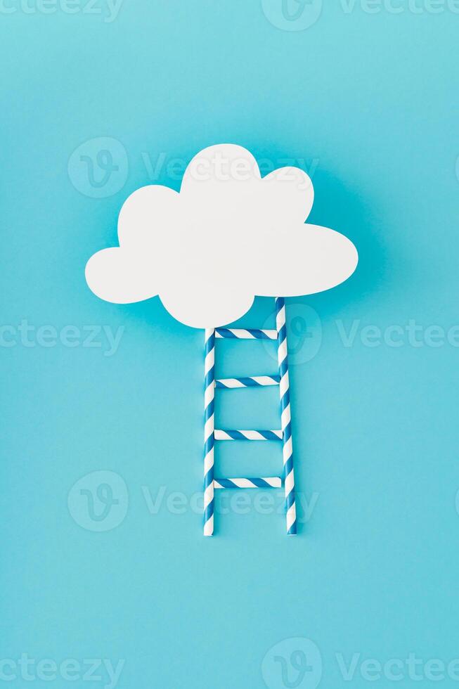 Step ladder made of paper drinking straws leading to cloud made of white paper card note on light pastel blue background. Minimal growth, future, development concept. Flat lay, top view banner. photo