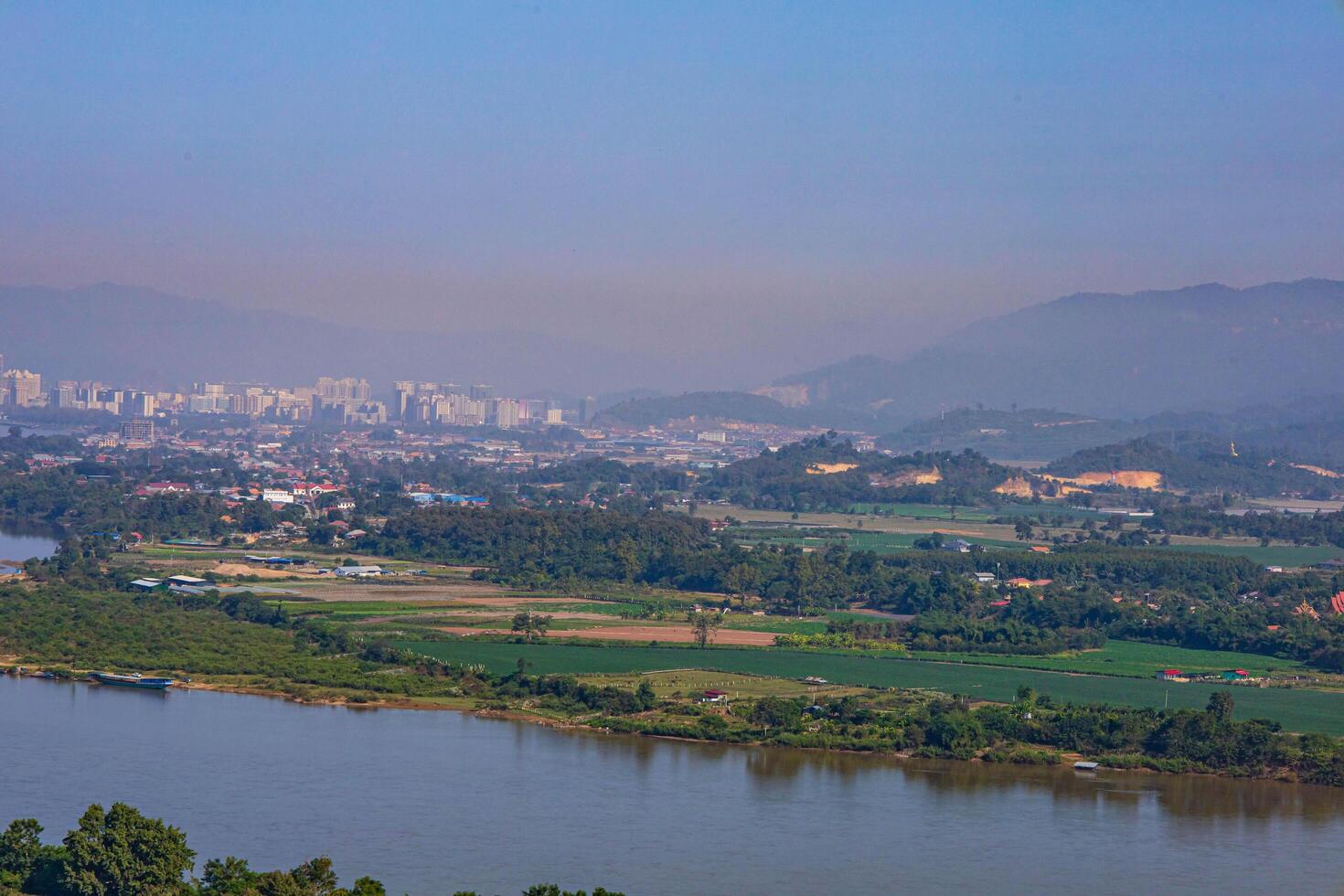 An aerial view of the skyline with mountains in the background and the river that separates the two countries. Chiang Saen, Thailand. photo