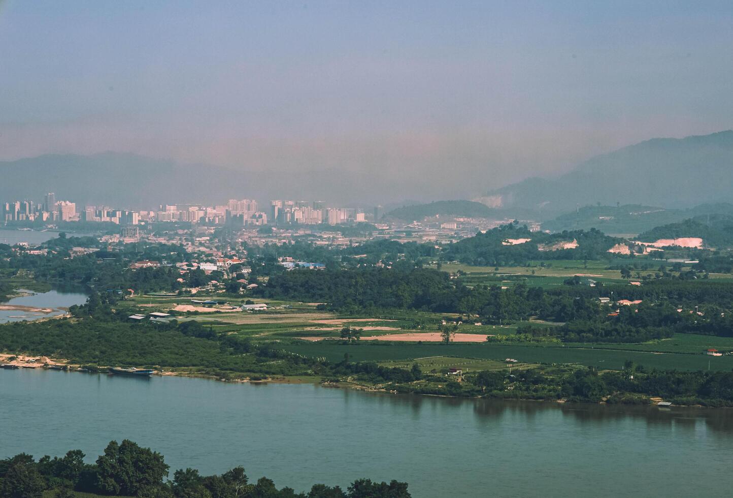 An aerial view of the skyline of Chiang Saen, Thailand with mountains in the background and the river that separates the two countries. photo