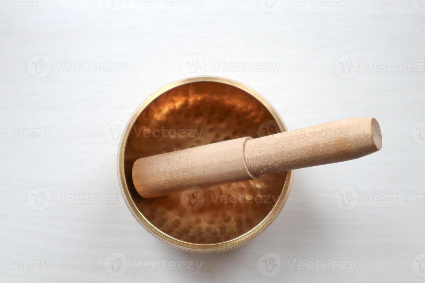 Singing bowl on a white background. Sound healing. photo