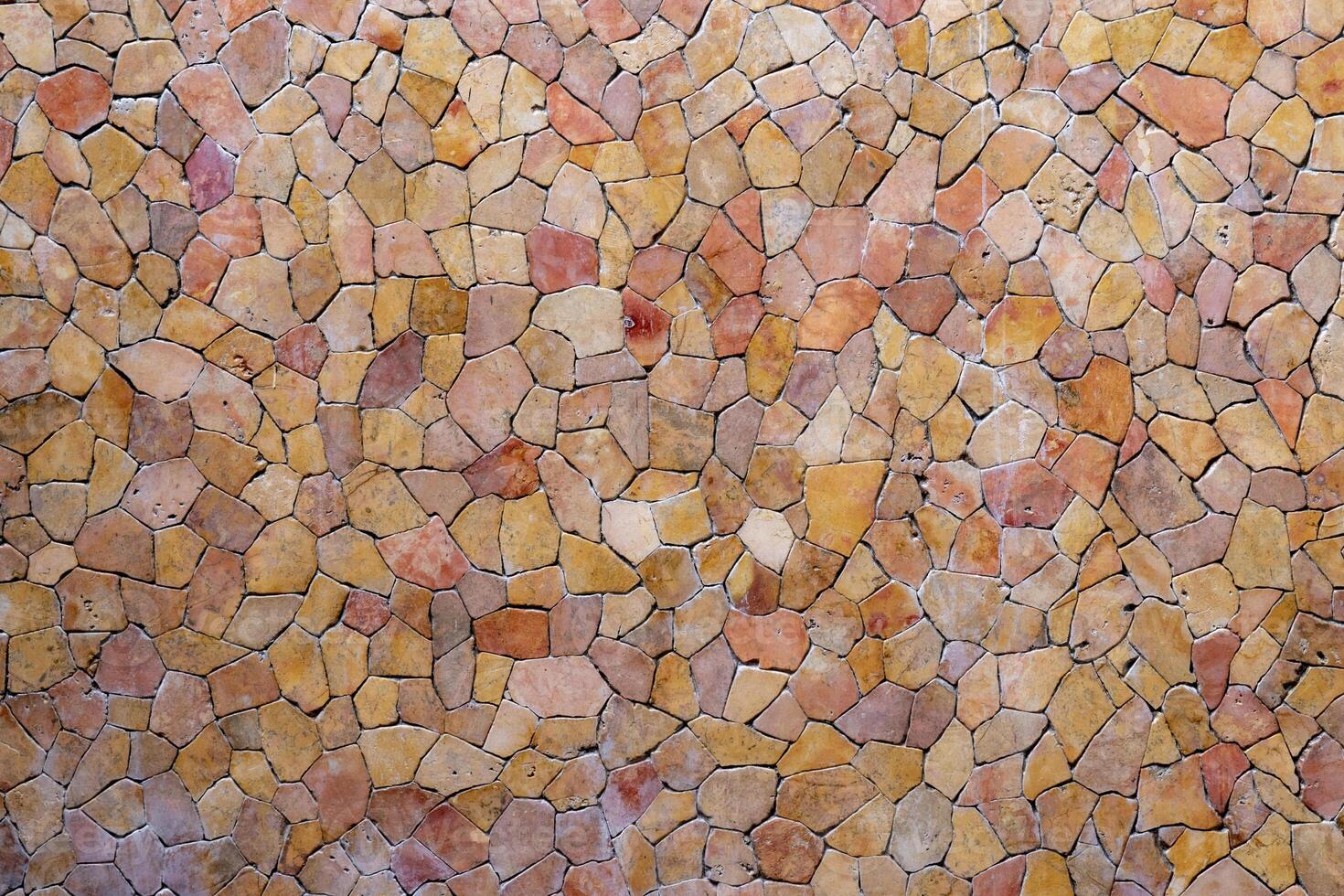 Tile pieces are arranged like a mosaic on the wall. Abstract background of wall texture. photo