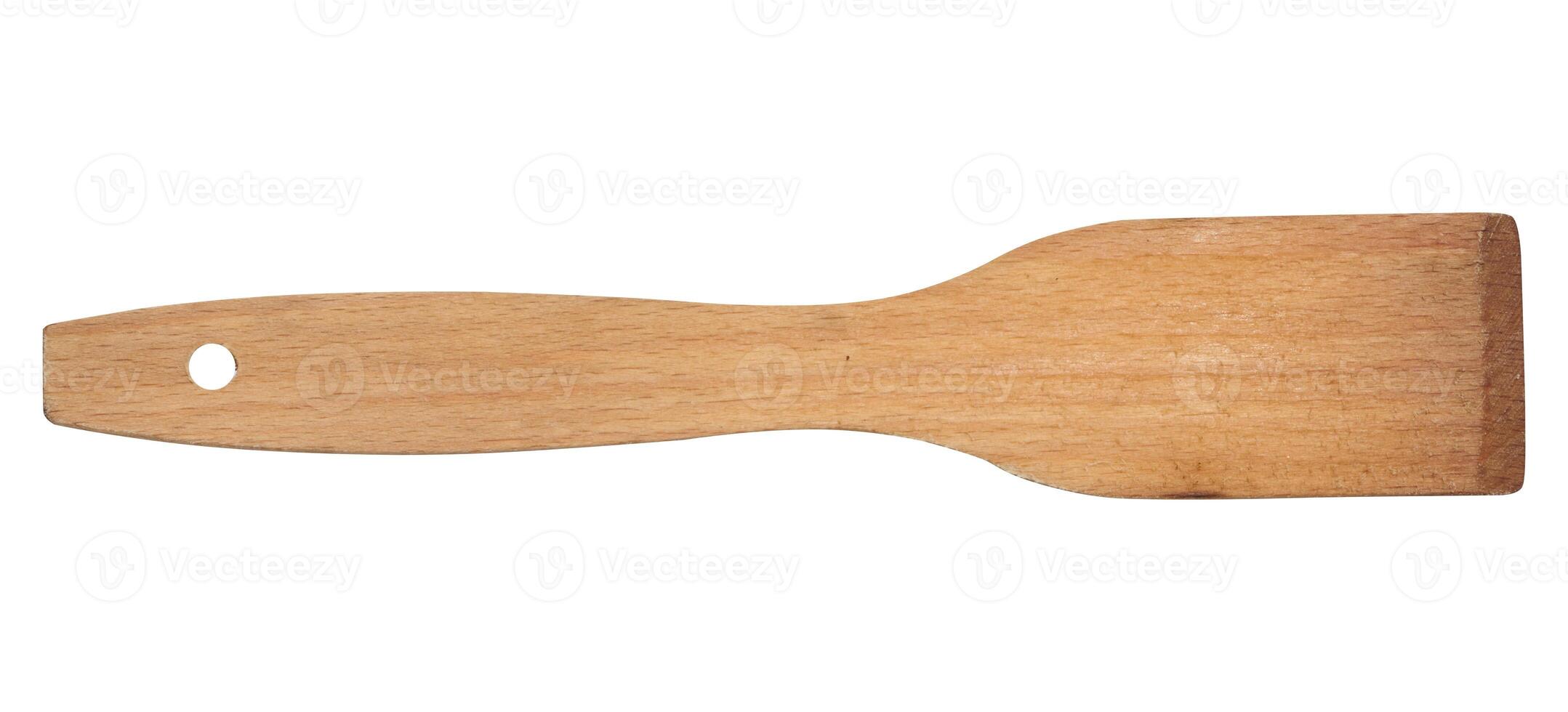 Wooden kitchen spatula on isolated background, top view photo