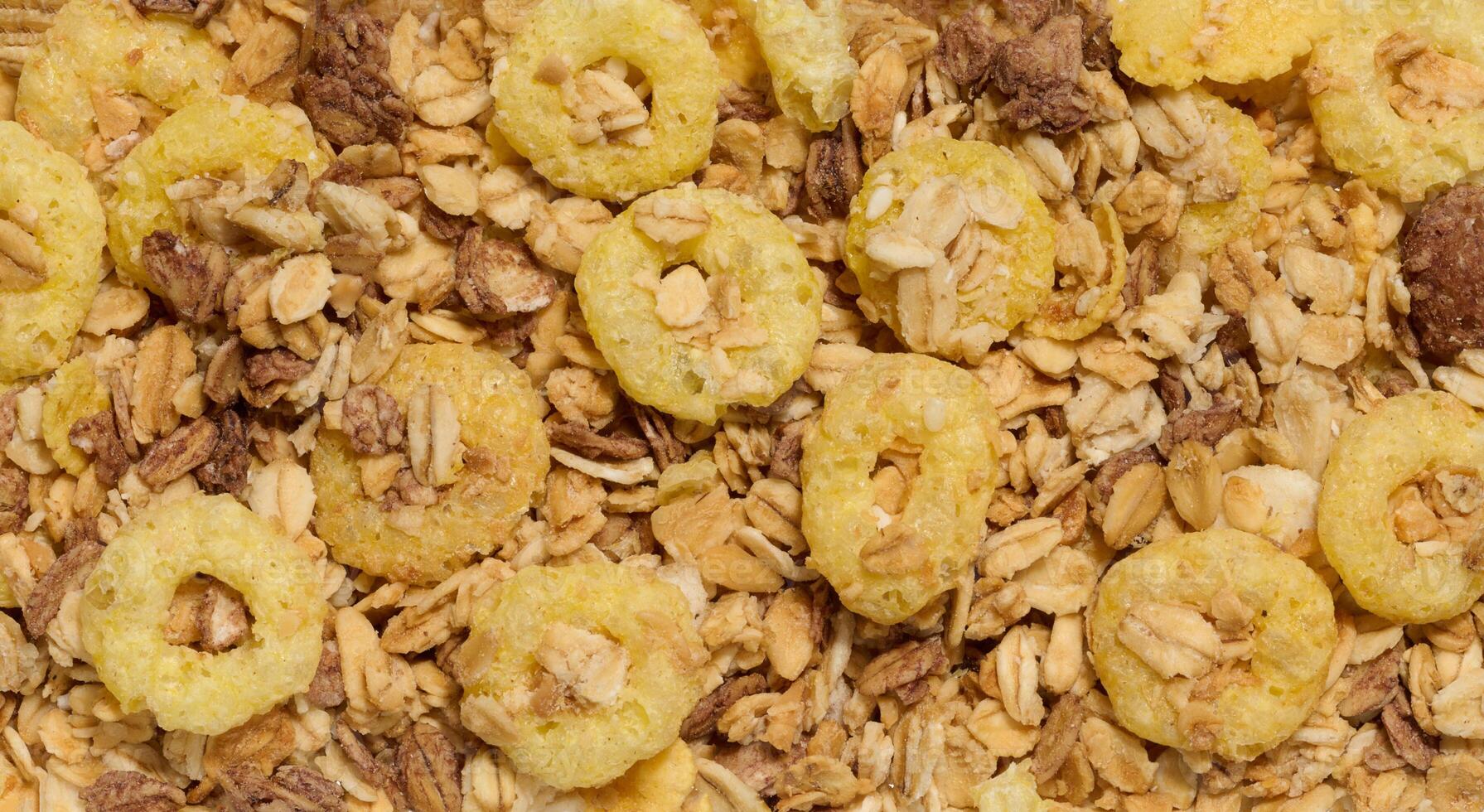 Crunchy breakfast cereal and oat granola mix, featuring puffed corn rings, toasted oats, and nuts. A nutritious and delicious option for a healthy meal. photo