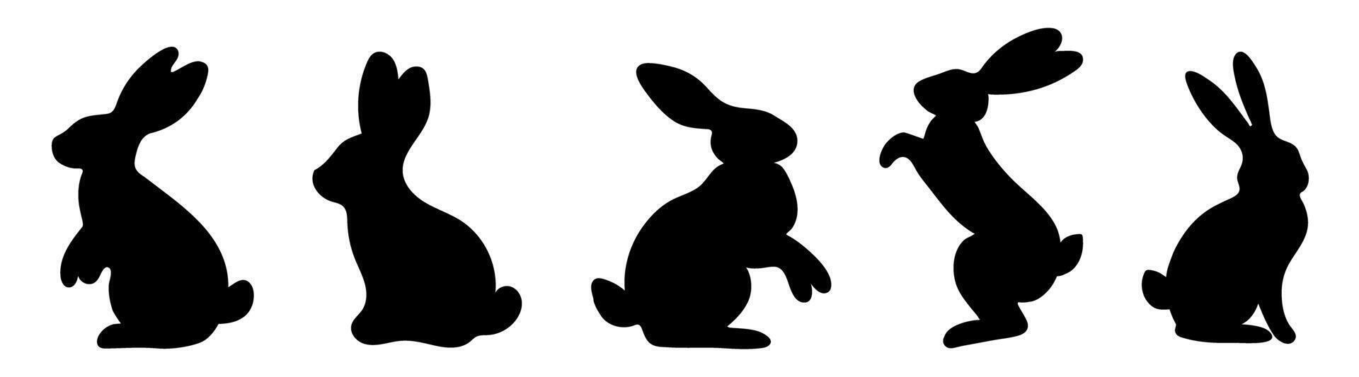 Set of black silhouettes of rabbits in different poses vector