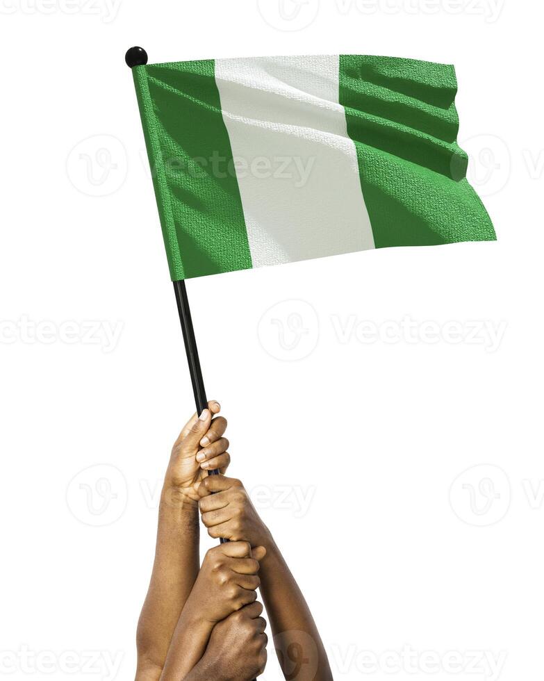 Many different group black African hands holding lifting raising Nigerian national flag isolated over white background. Stretching arms for flag. Togetherness, unity independence day celebration photo