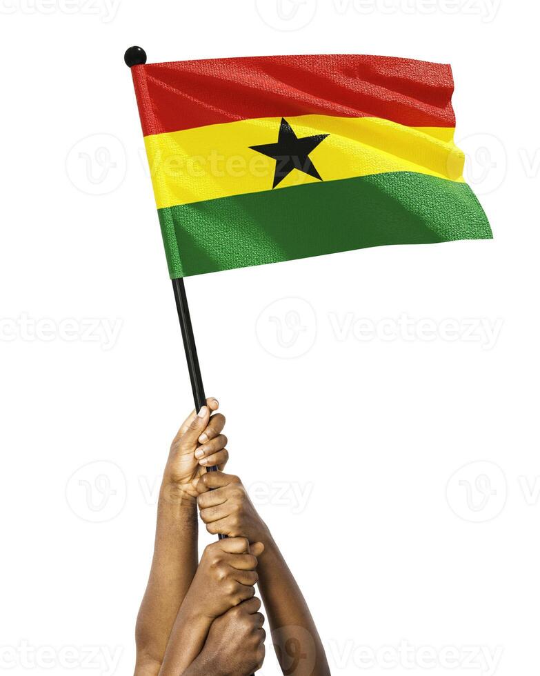 Many different group black African hands holding lifting raising Ghanaian national flag isolated over white background. Stretching arms for flag. Togetherness, unity independence day celebration photo