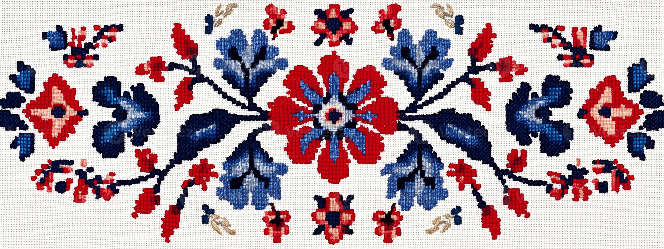 A cross stitch pattern with red, blue and white flowers photo