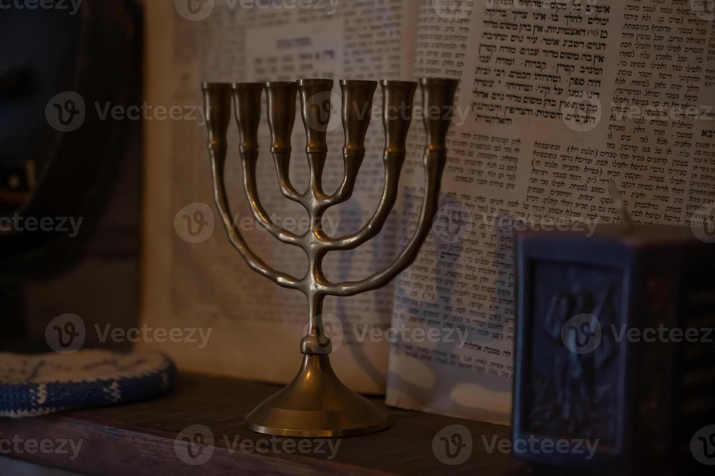 A gold menorah is displayed on a shelf in a jewish home photo
