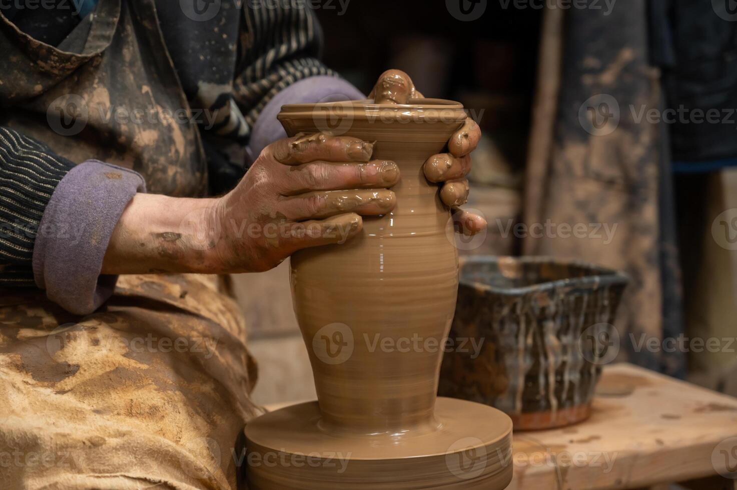 a potter is making a pot on a potter's wheel photo