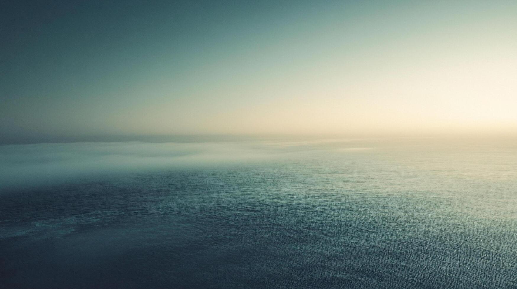 Serene ocean view with a light sky fading into fog over the horizon, creating a sense of calm and vastness, inviting contemplation. photo