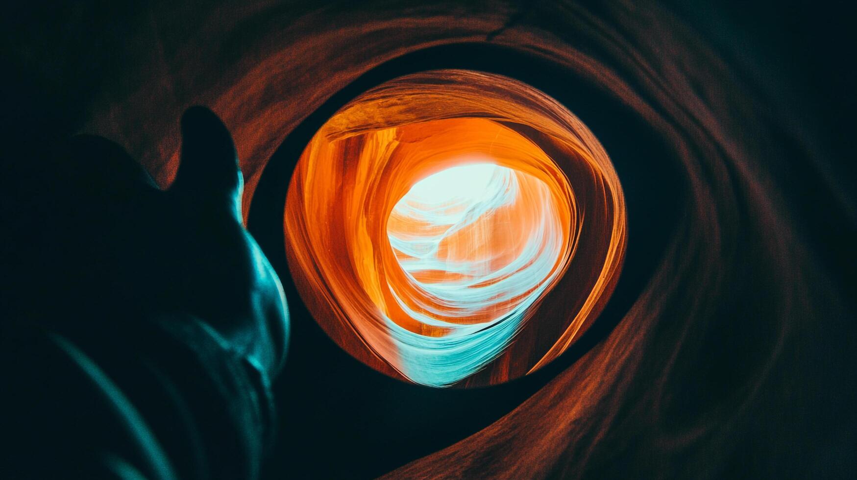 Dramatic rock formation with swirling orange and teal hues, contrasting light and shadow, creating an abstract geological spectacle. photo
