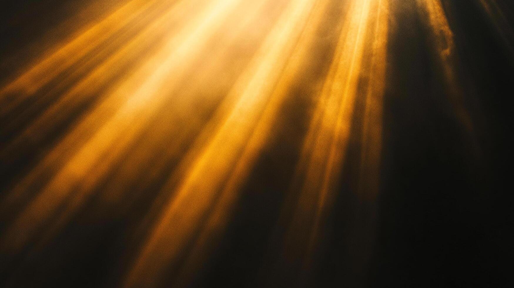 Golden light streams through an opening, casting bright rays onto the dark surface below, creating a contrast between light and shadow. photo