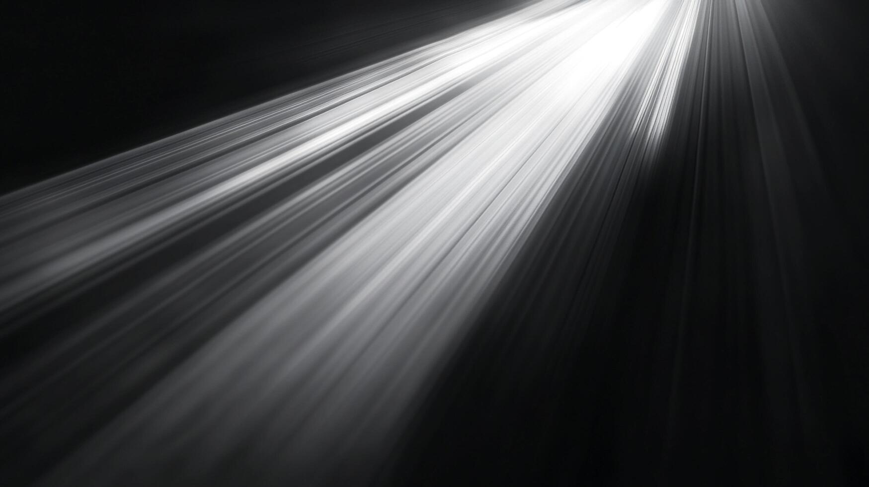 Radiant beams of light pierce through the darkness, creating a dramatic and ethereal scene. The monochromatic palette enhances the effect. photo