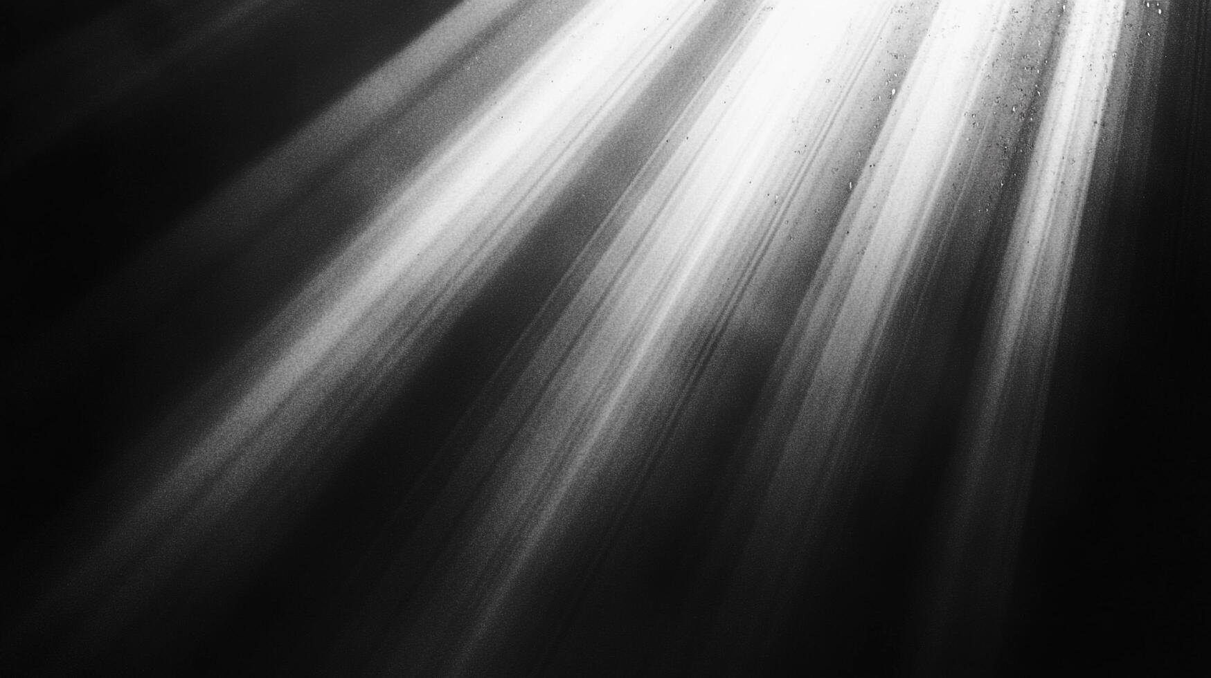 Striking black and white image showcasing dramatic light rays piercing through darkness, creating a captivating interplay of light and shadow. photo