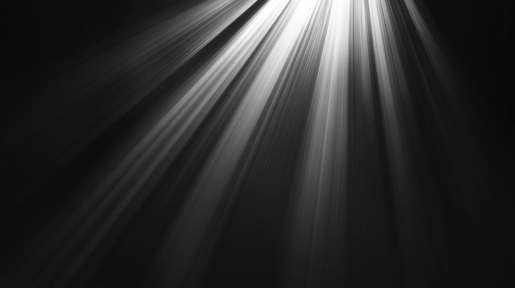 Rays of light stream down in the darkness, illuminating the unseen below. The glow creates ethereal contrast. photo